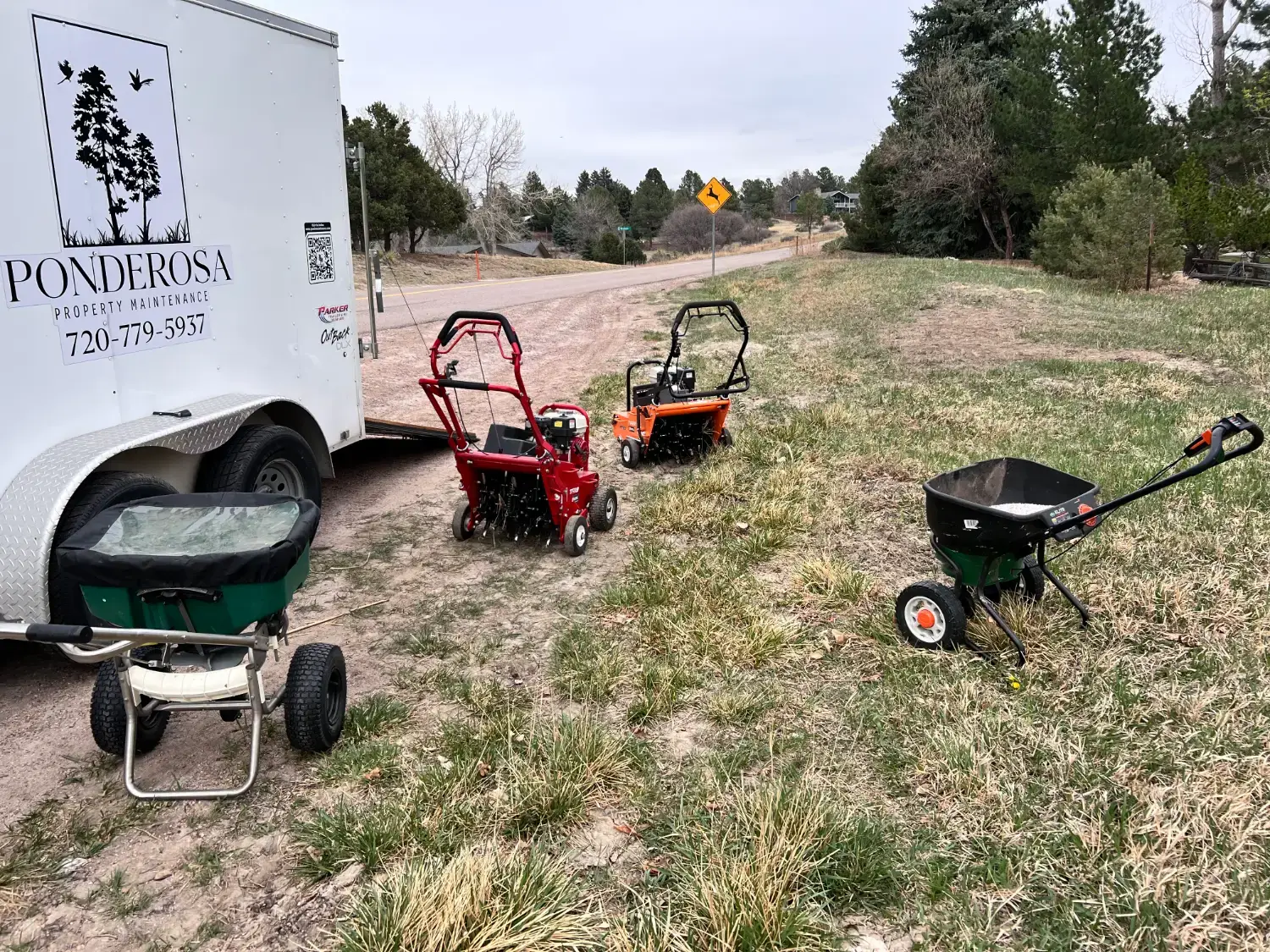 Aerators and spreaders lined up beside the Ponderosa trailer